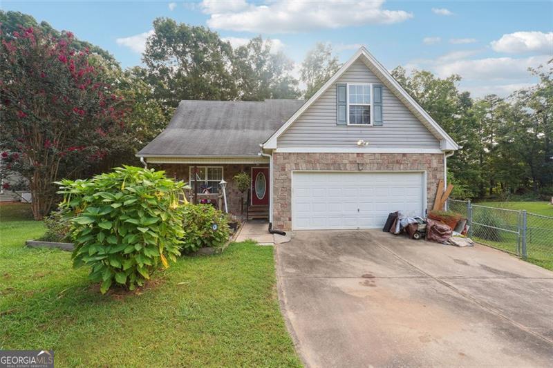 a view of a house with yard and sitting area