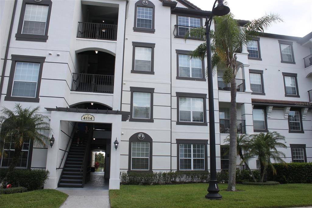 a front view of a residential apartment building with a yard