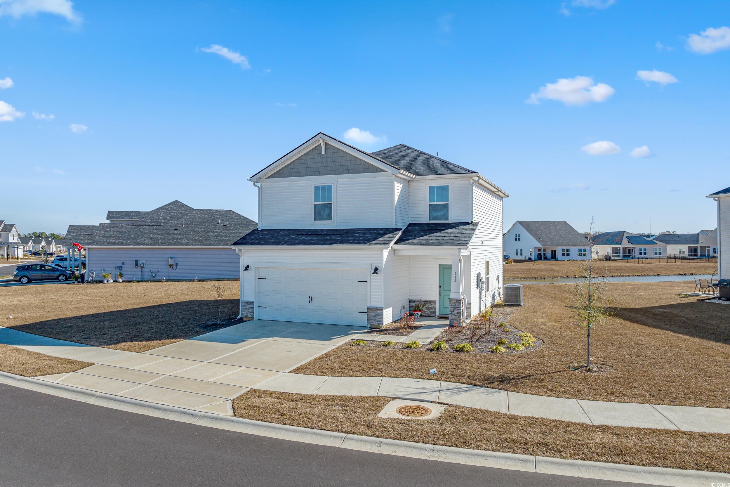 View of front property featuring a garage and cent