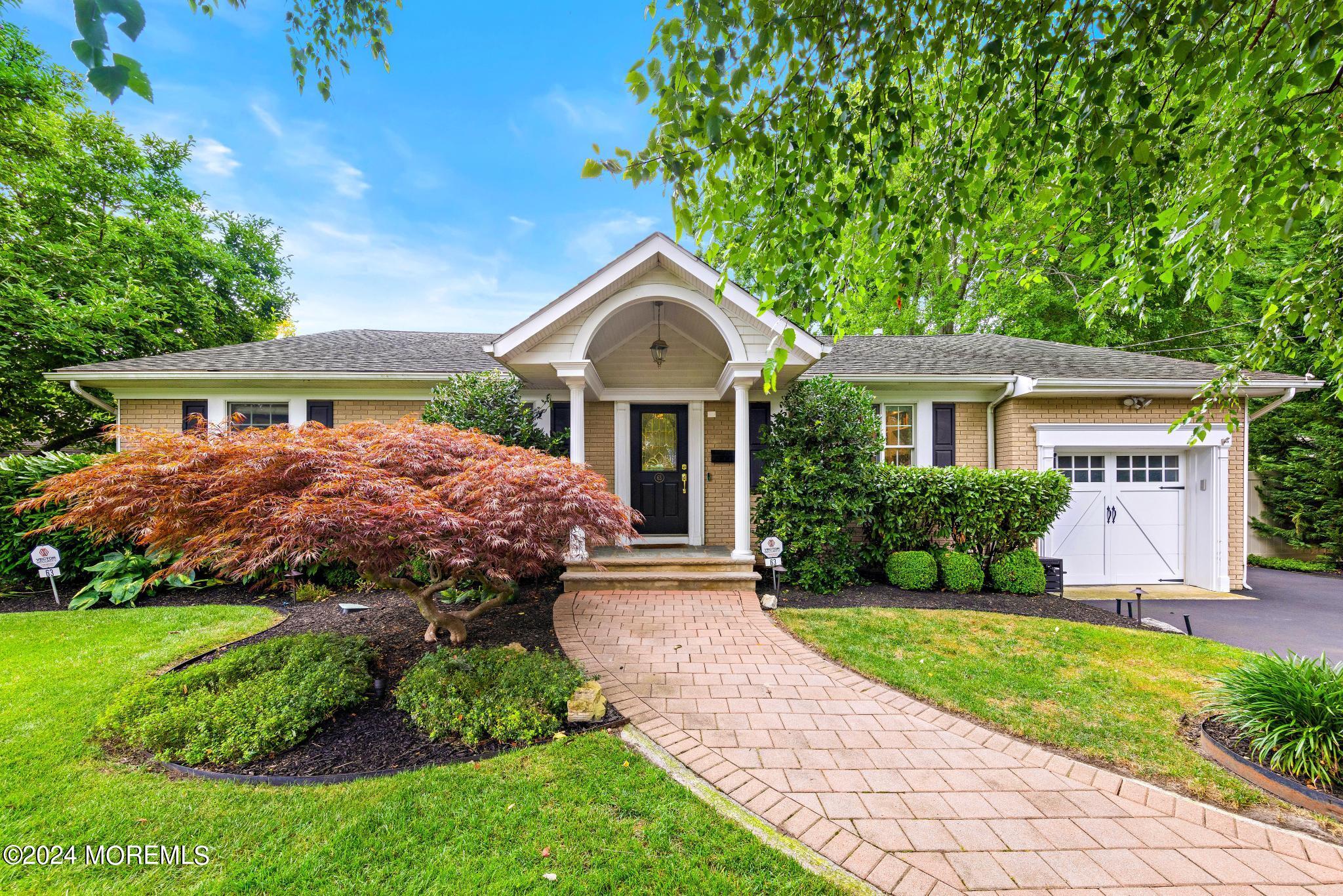 a front view of a house with a yard and porch