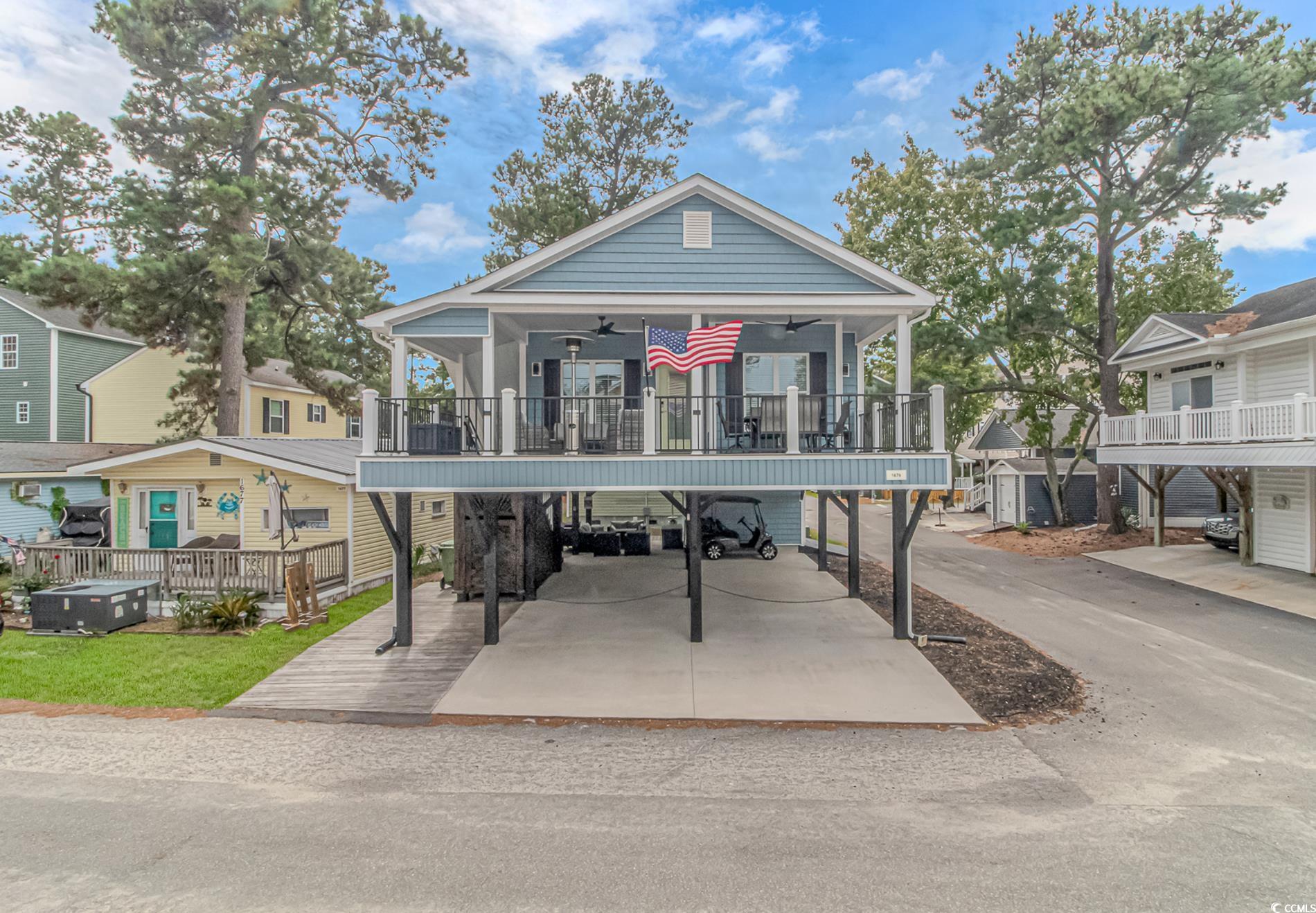 View of front of property with a carport and a por