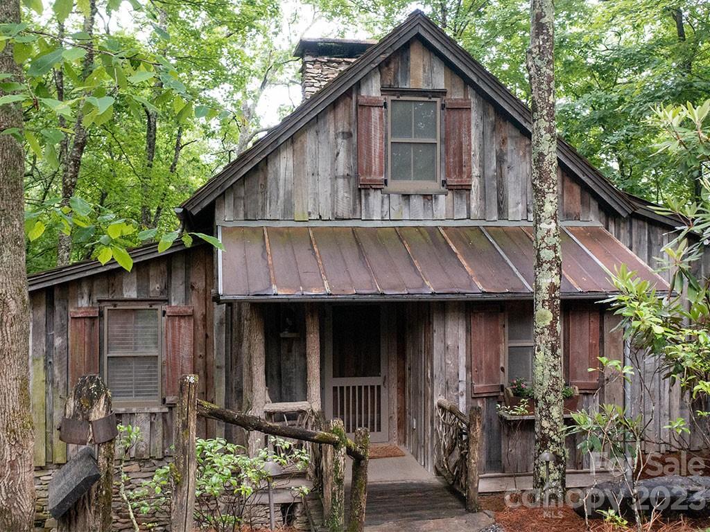 a small barn in front of a house