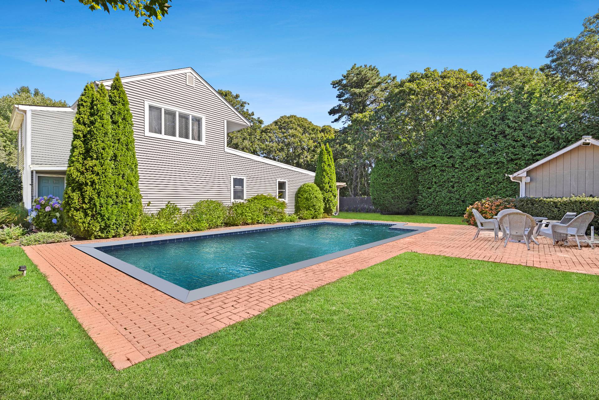 a view of an house with swimming pool garden and patio