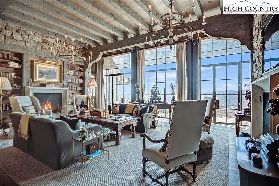 a living room with furniture a fireplace and a table