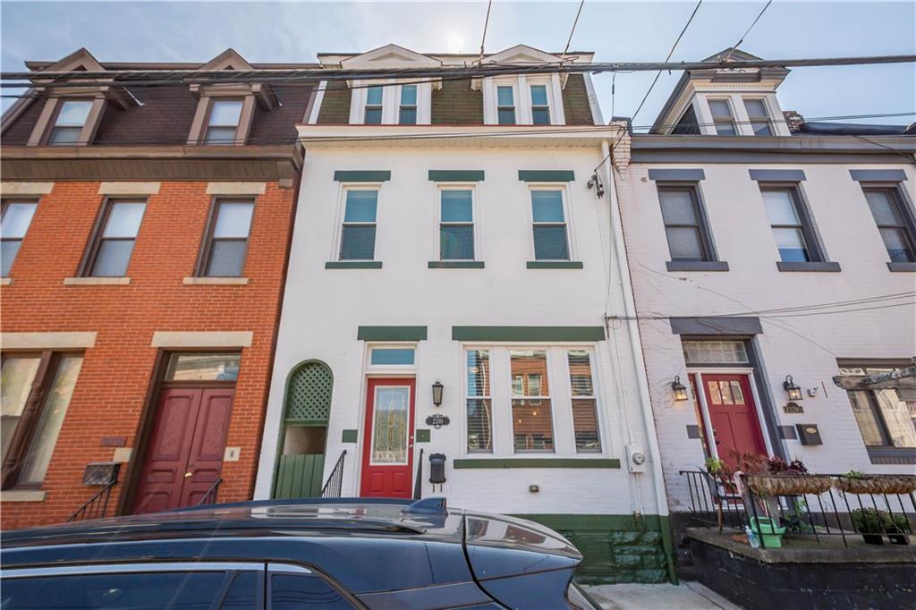 Freshly painted exterior on this Victorian beauty grabs your eye at the street. The red door pops. Even the breezeway is pretty with a lovely arch!