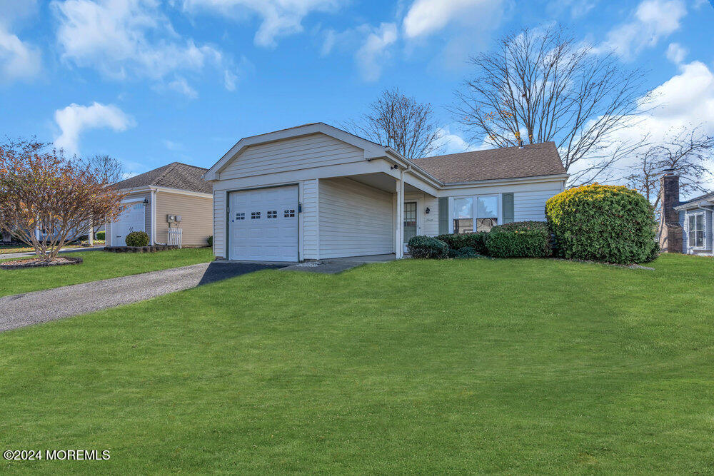 a front view of house with yard and green space