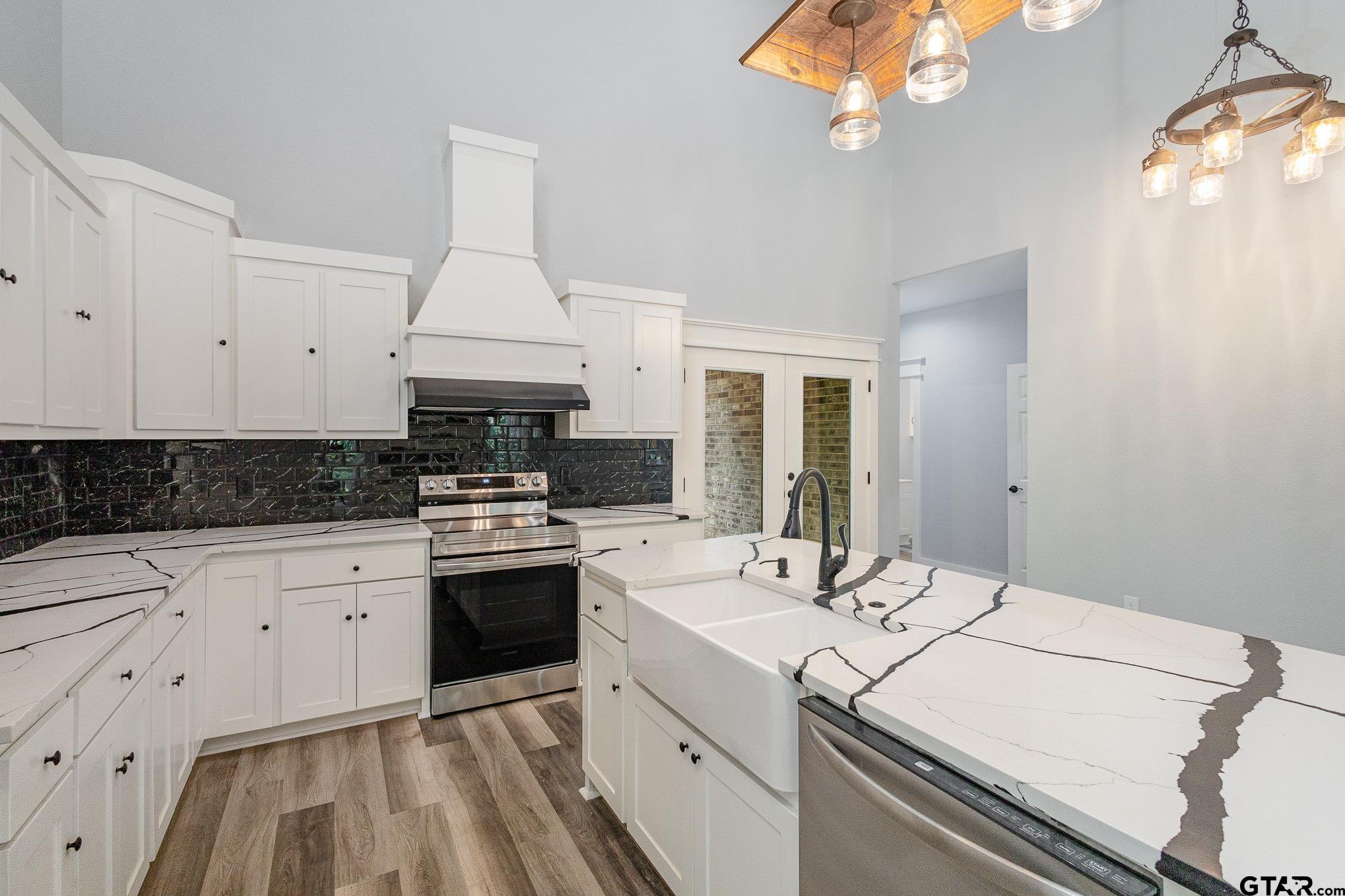 a kitchen that has a sink and a stove