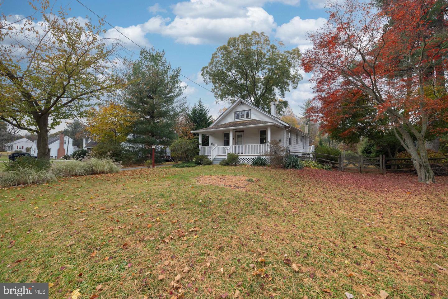 a front view of a house with a yard and trees