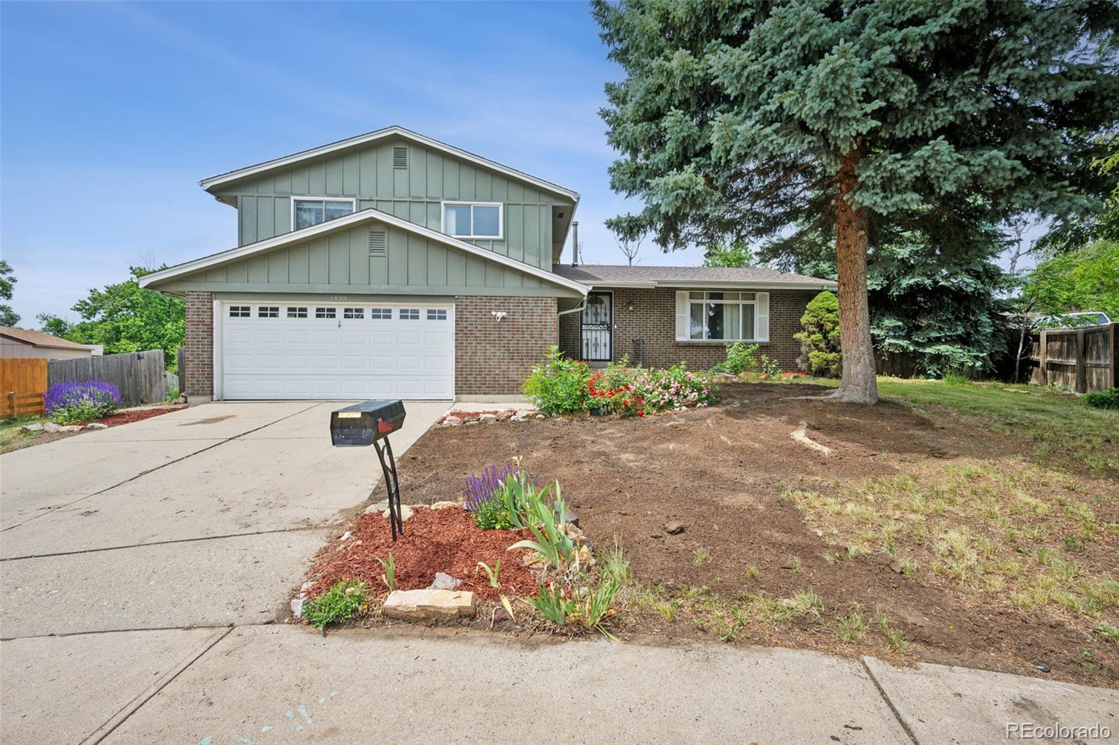 a front view of a house with a yard and garage