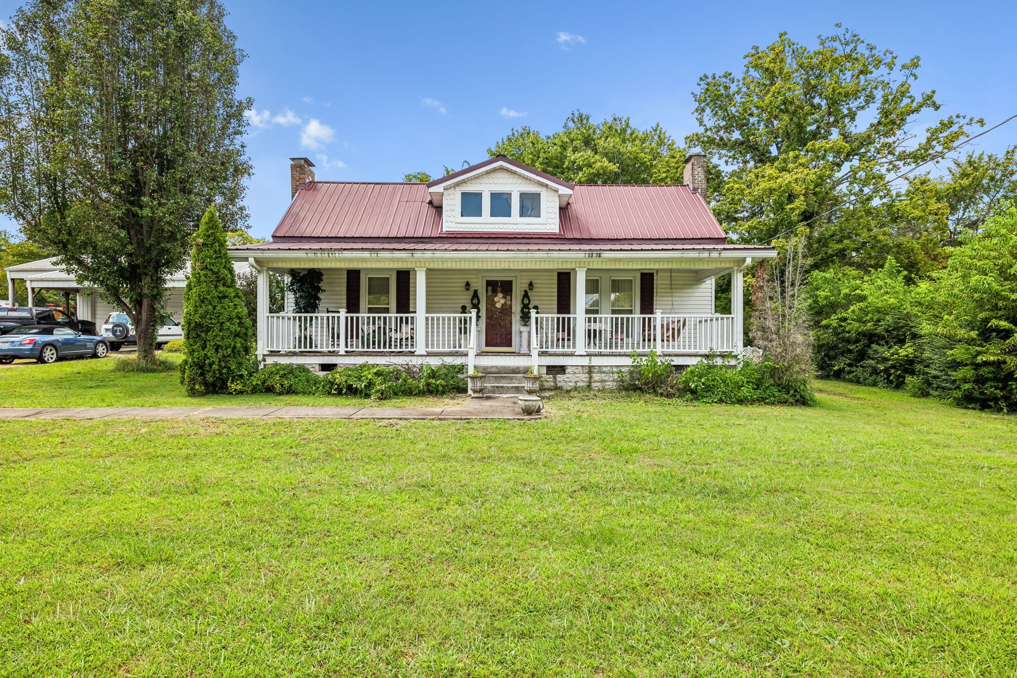 a front view of a house with a garden