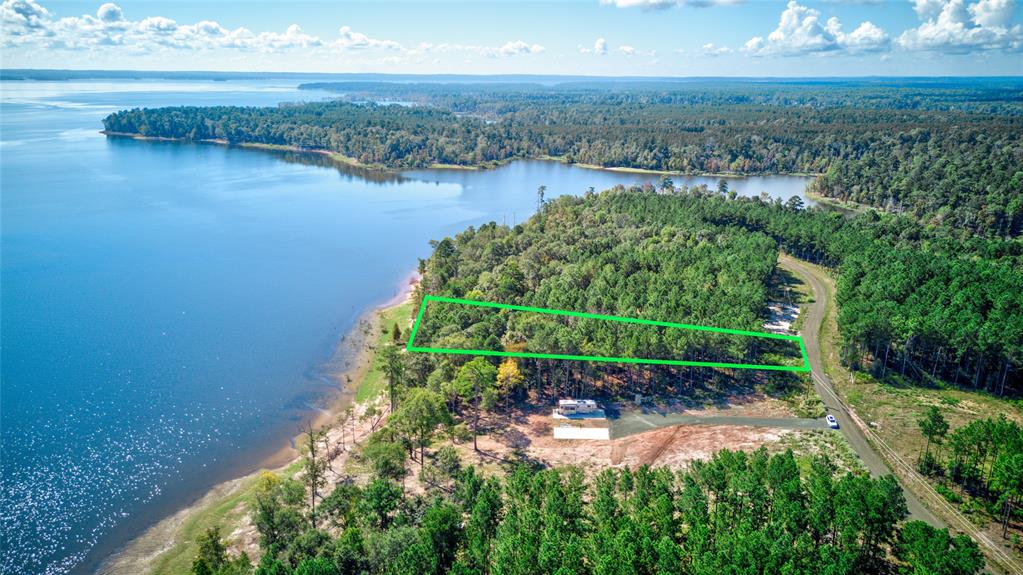 an aerial view of a houses with a lake view