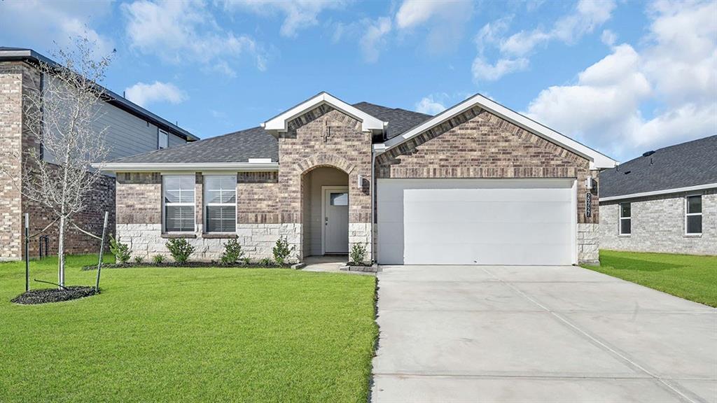 a front view of a house with a yard and garage