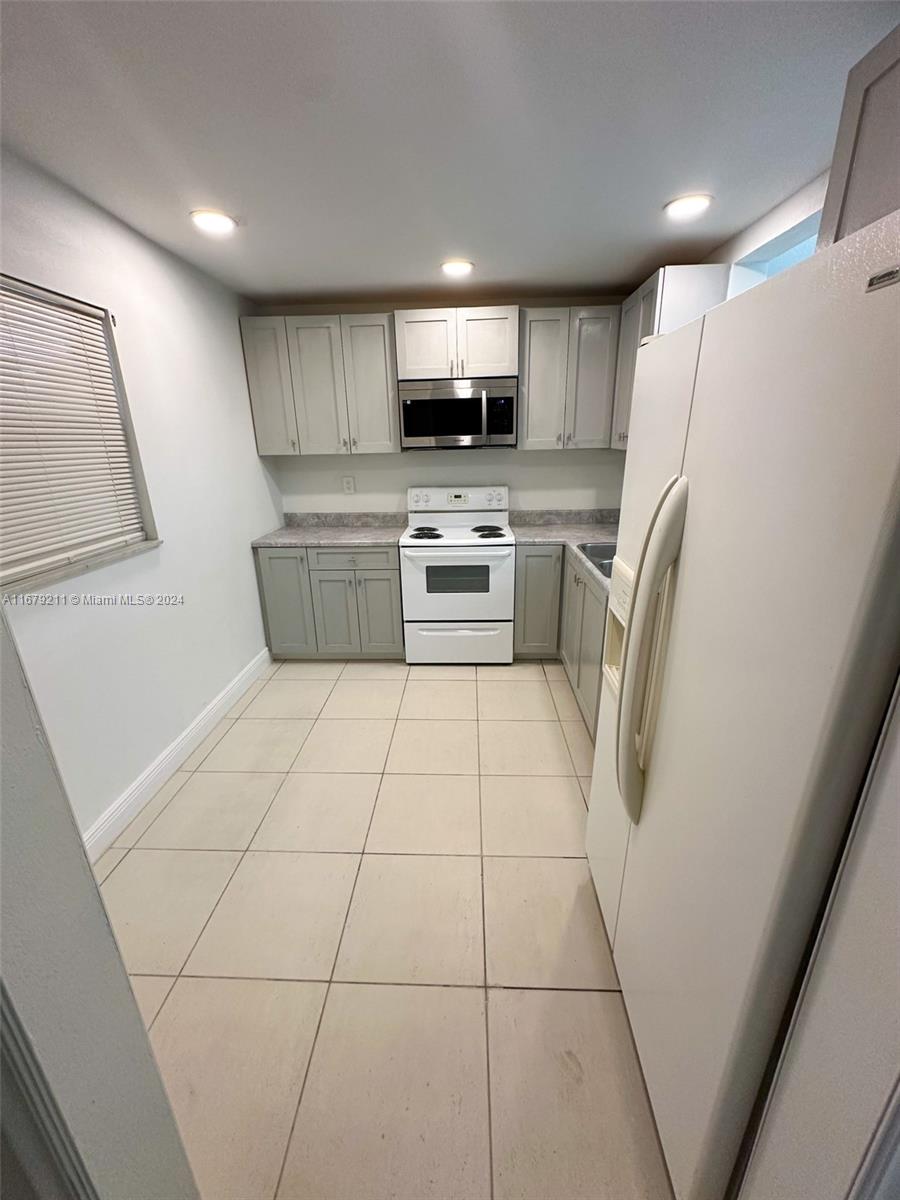 a kitchen with stainless steel appliances a refrigerator sink and microwave