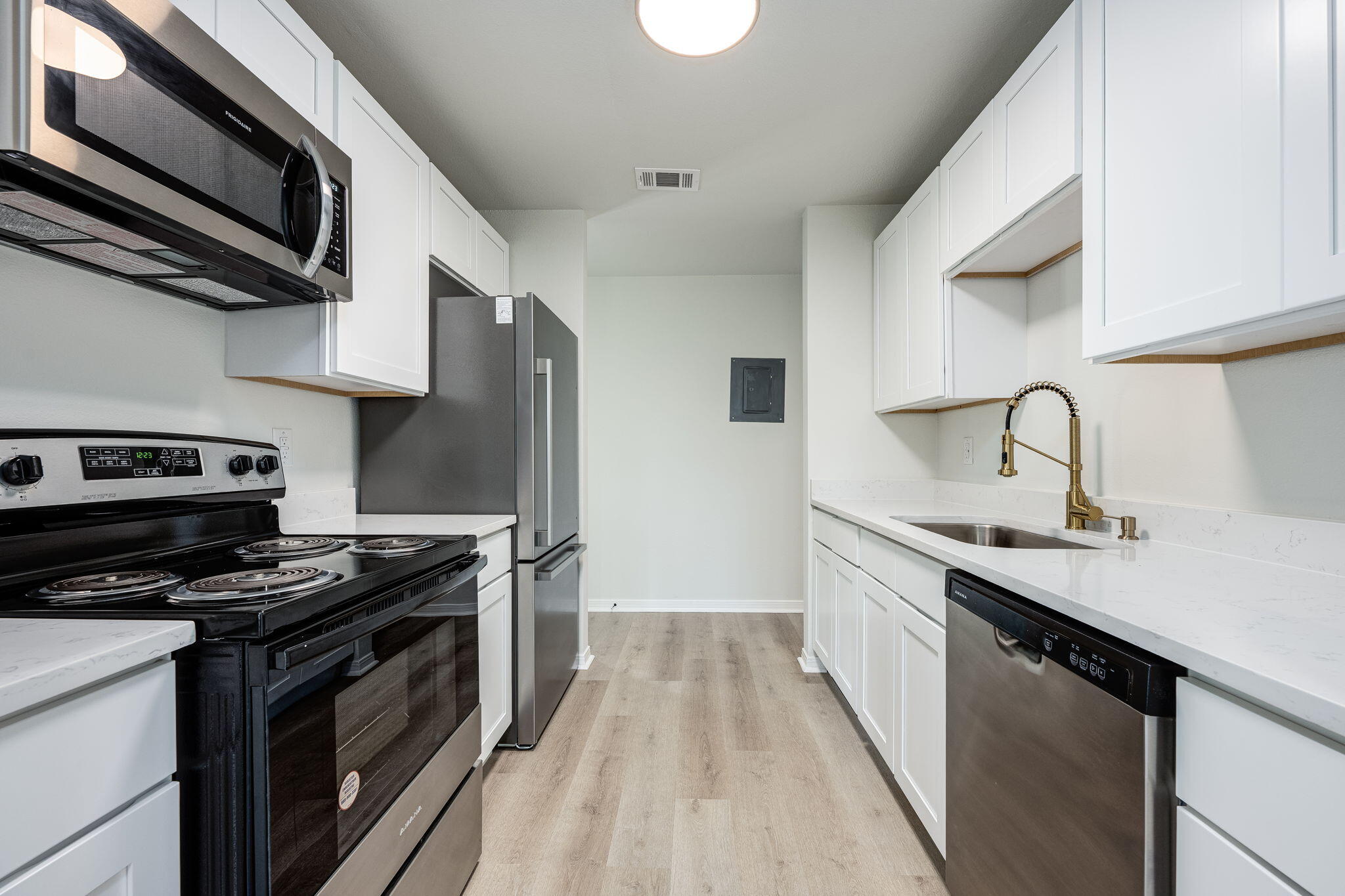 a kitchen with stainless steel appliances a stove sink and cabinets