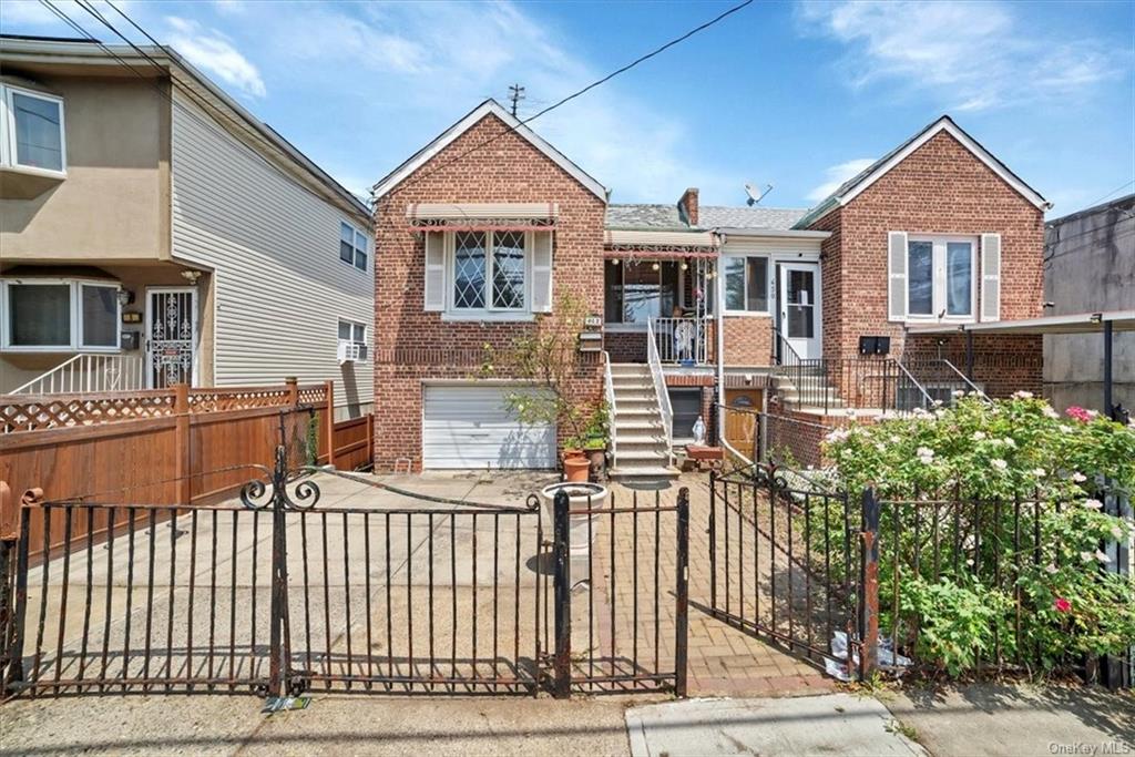 View of front of property. ALL BRICK. Plenty of potential parking space outside of garage / or front patio!