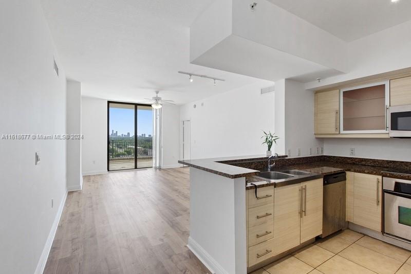 a kitchen with stainless steel appliances granite countertop a stove and a sink