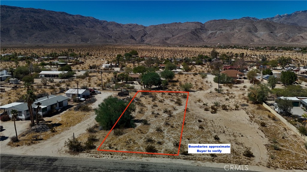 an aerial view of residential house and sandy dunes