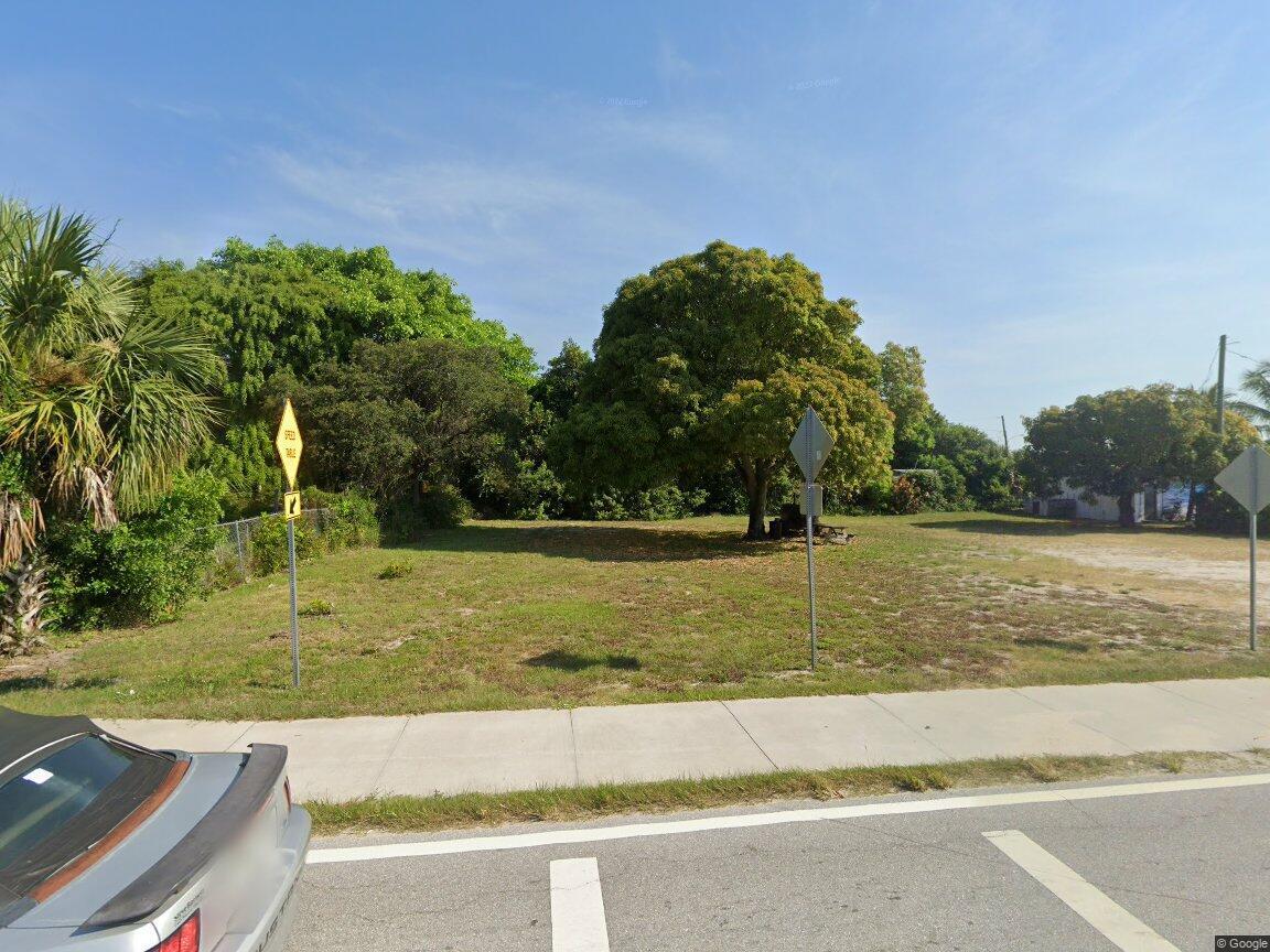 a view of a yard with large trees