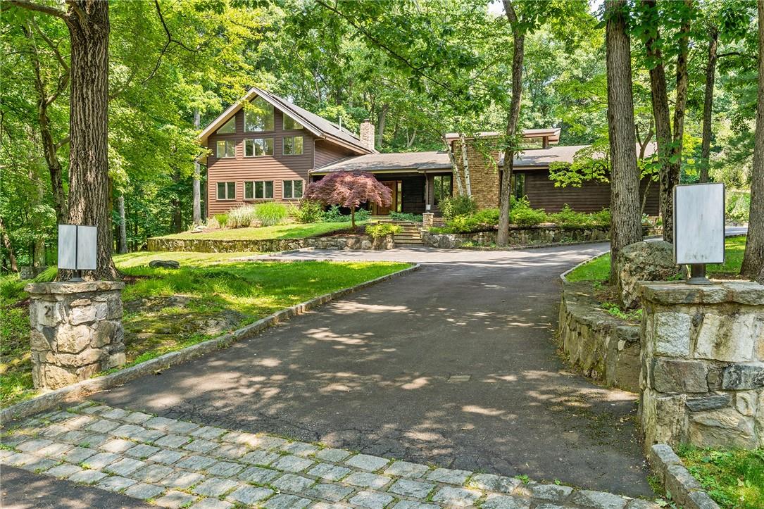 a front view of a house with yard and green space