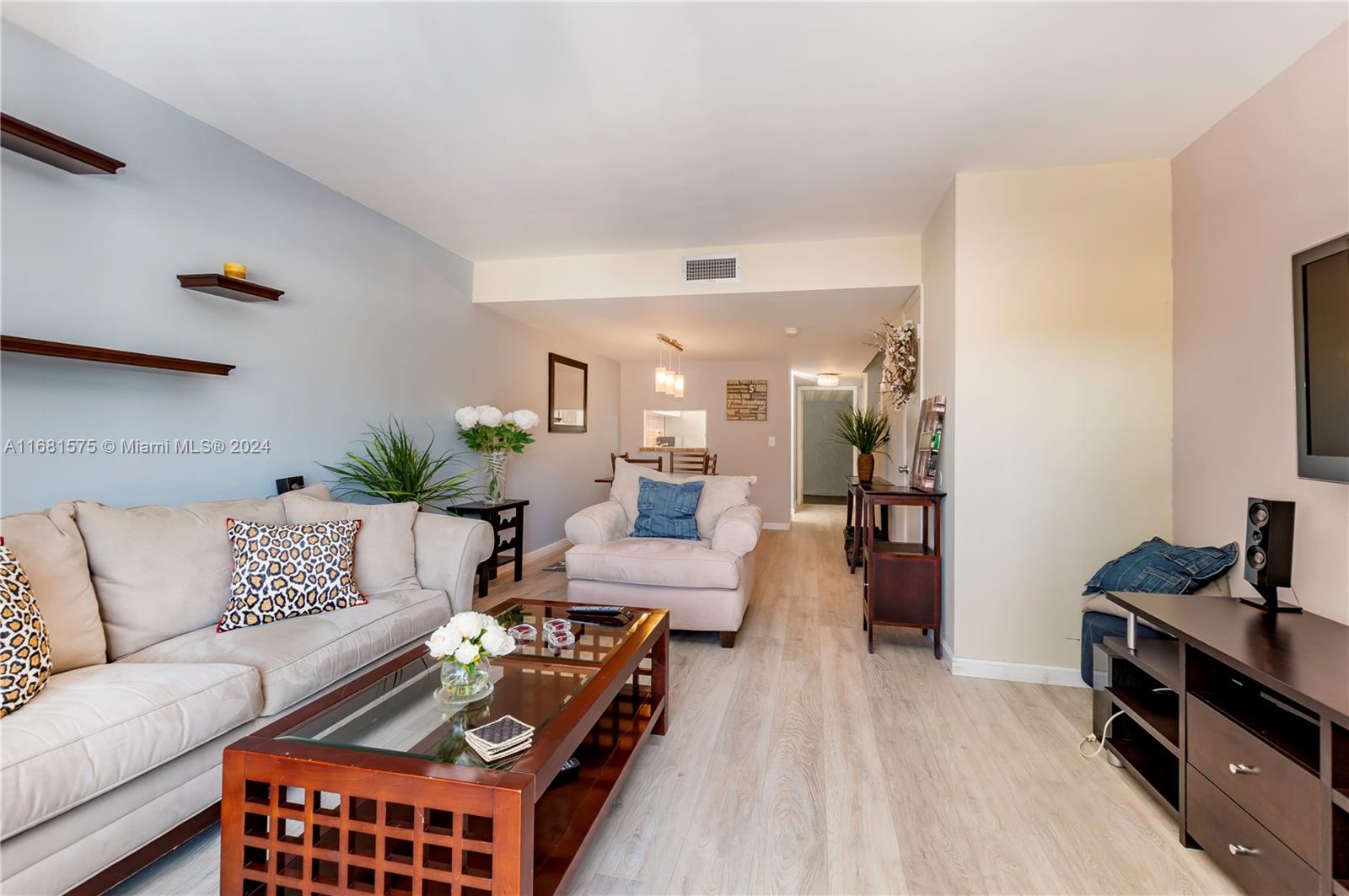 a living room with furniture a wooden floor and a sink