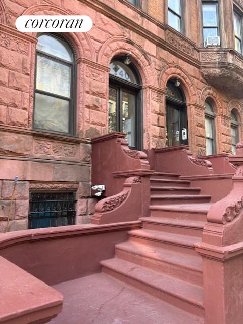 a view of front door of house with stairs