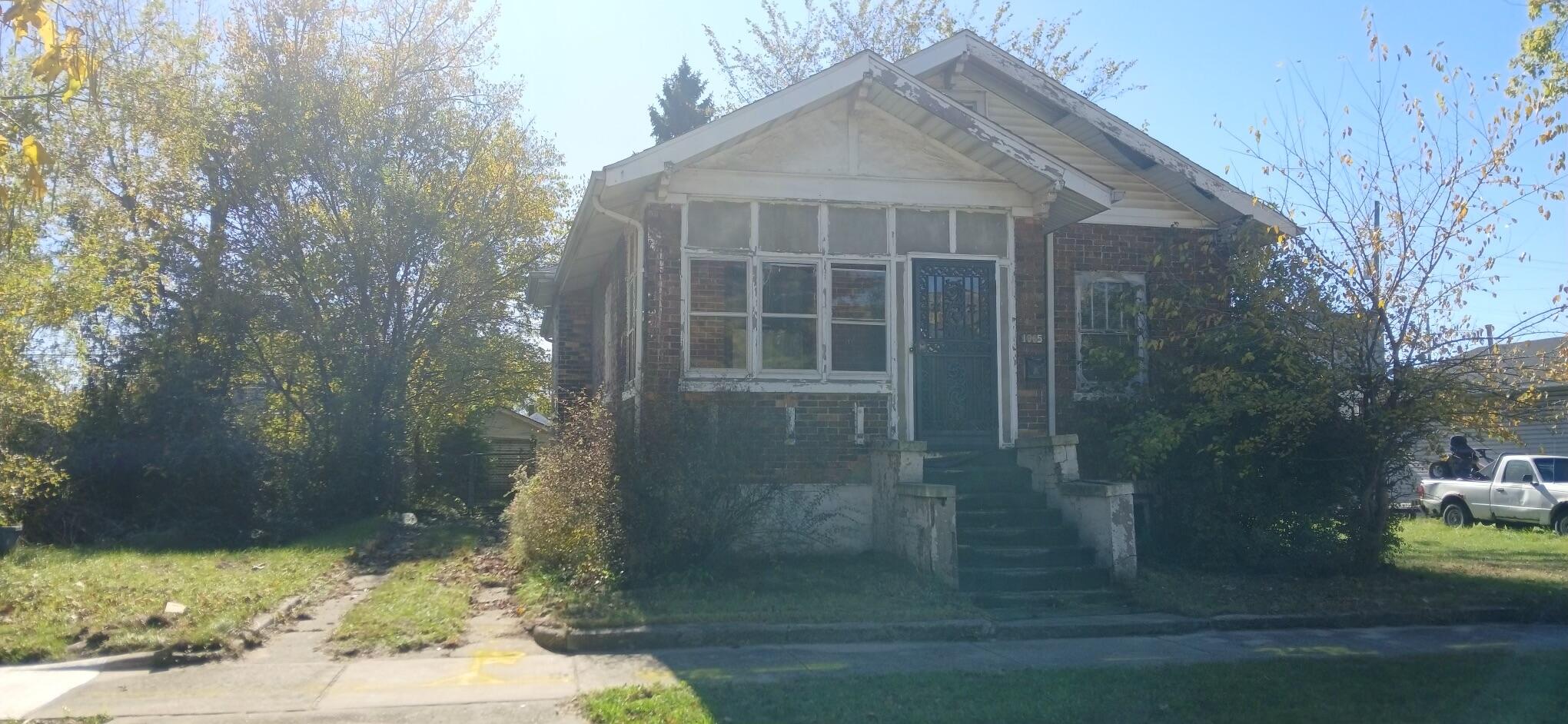 a view of a brick house with a yard