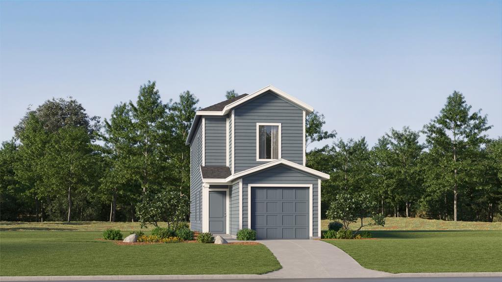 View of front of property featuring a garage and a front lawn