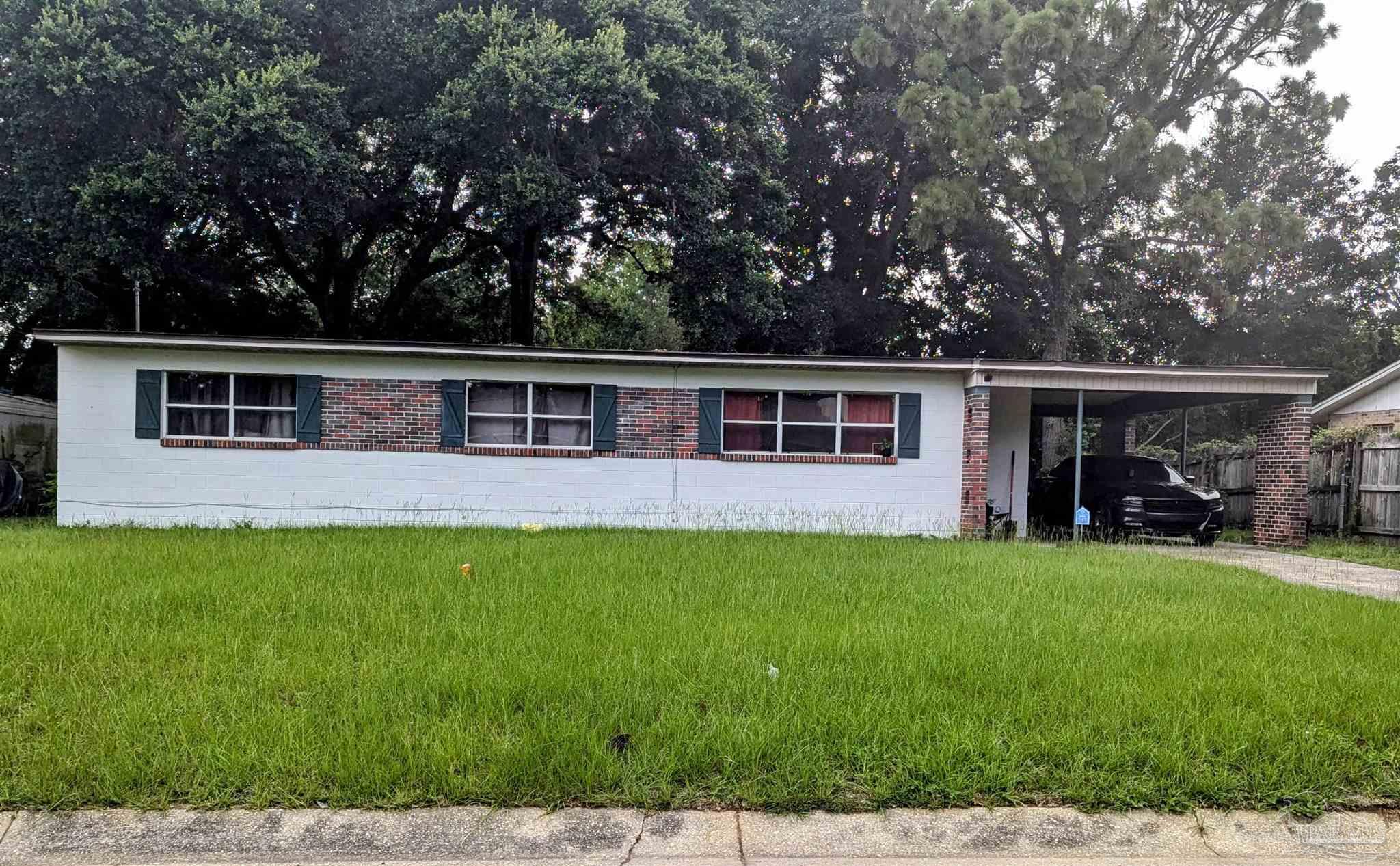 a view of a house with backyard porch and garden