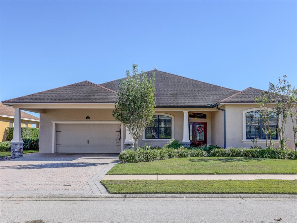 Front of the home with a large garage and a porte-cochere.