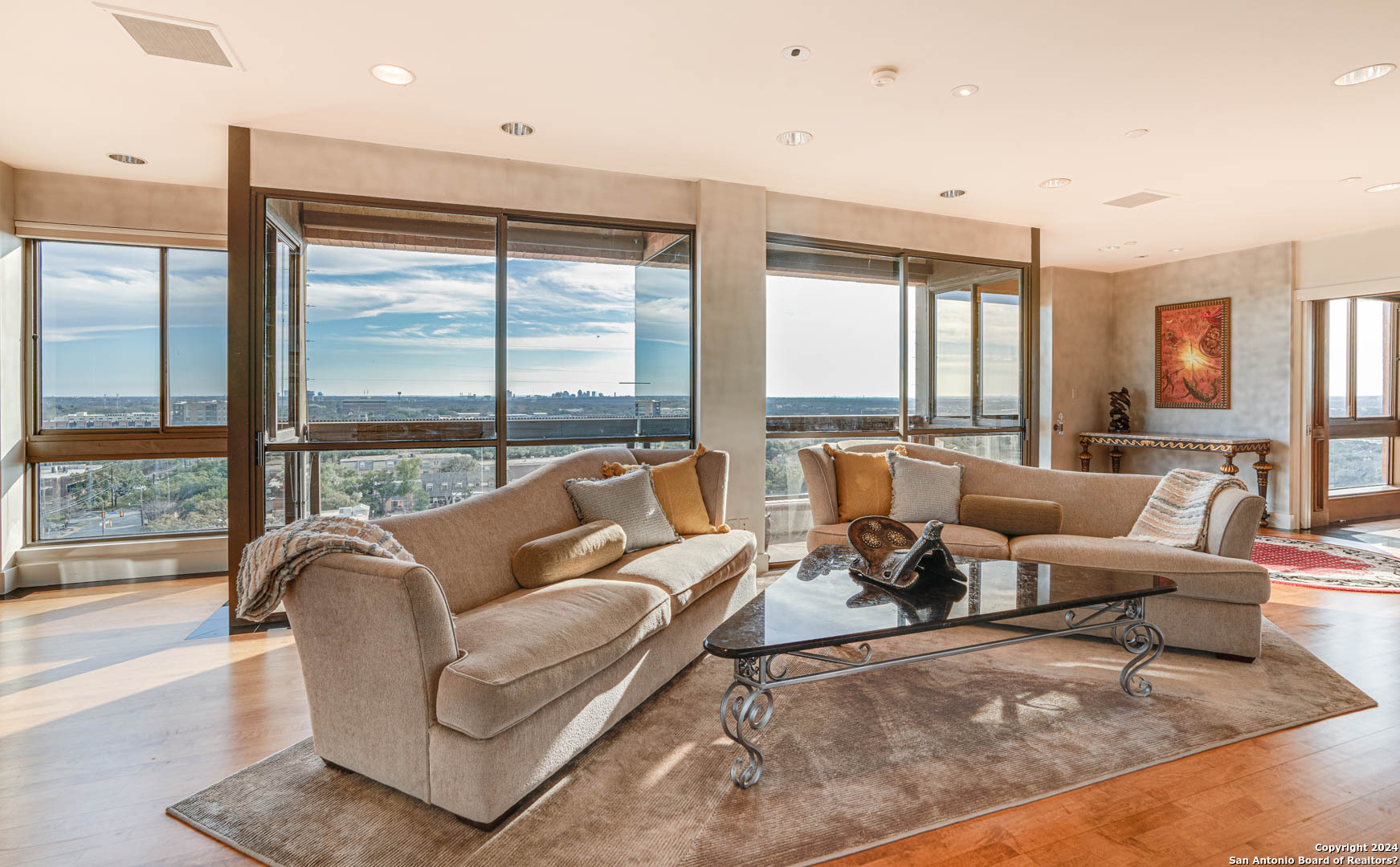 a living room with furniture and large windows