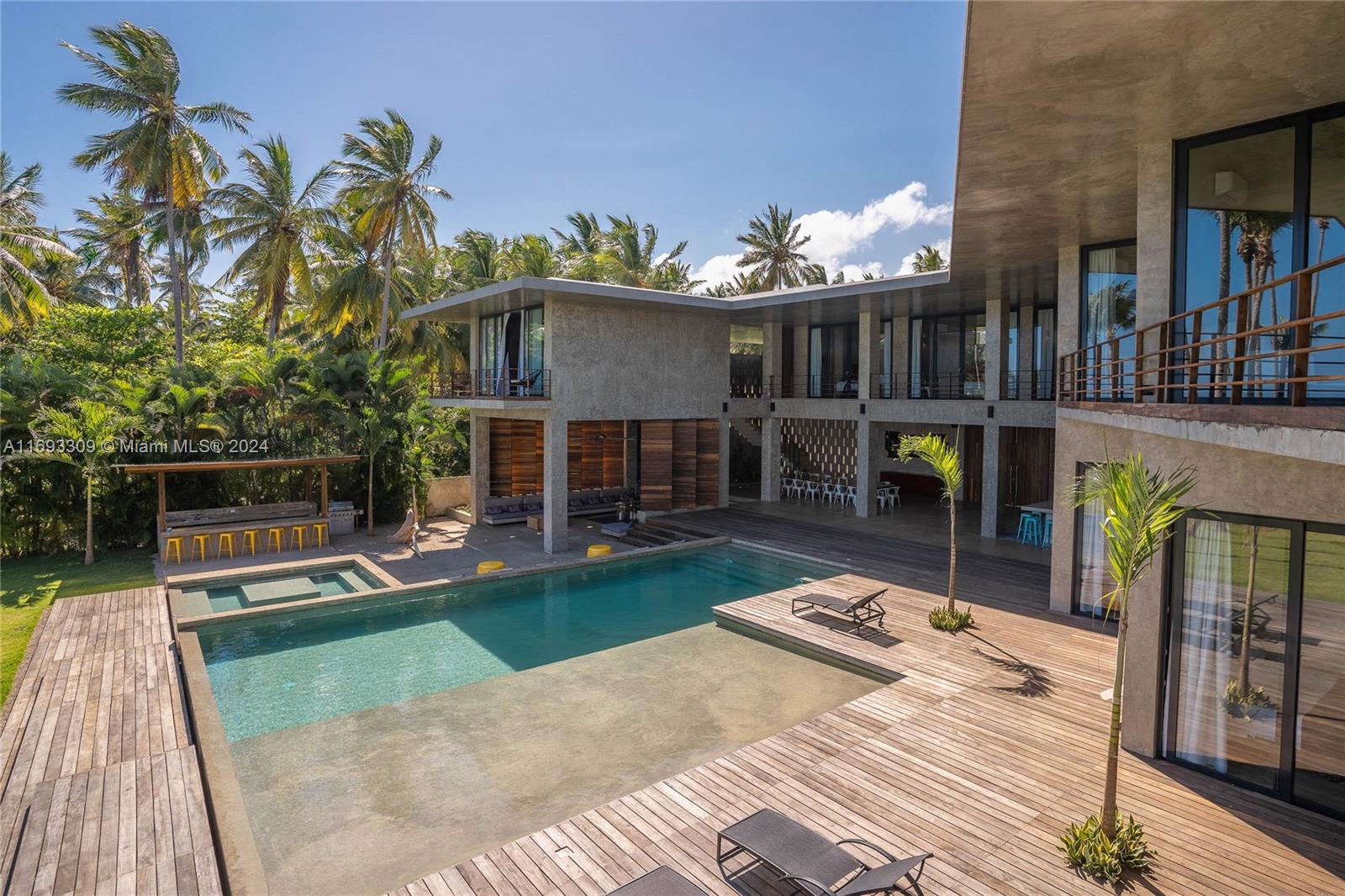 a view of a house with backyard porch and sitting area