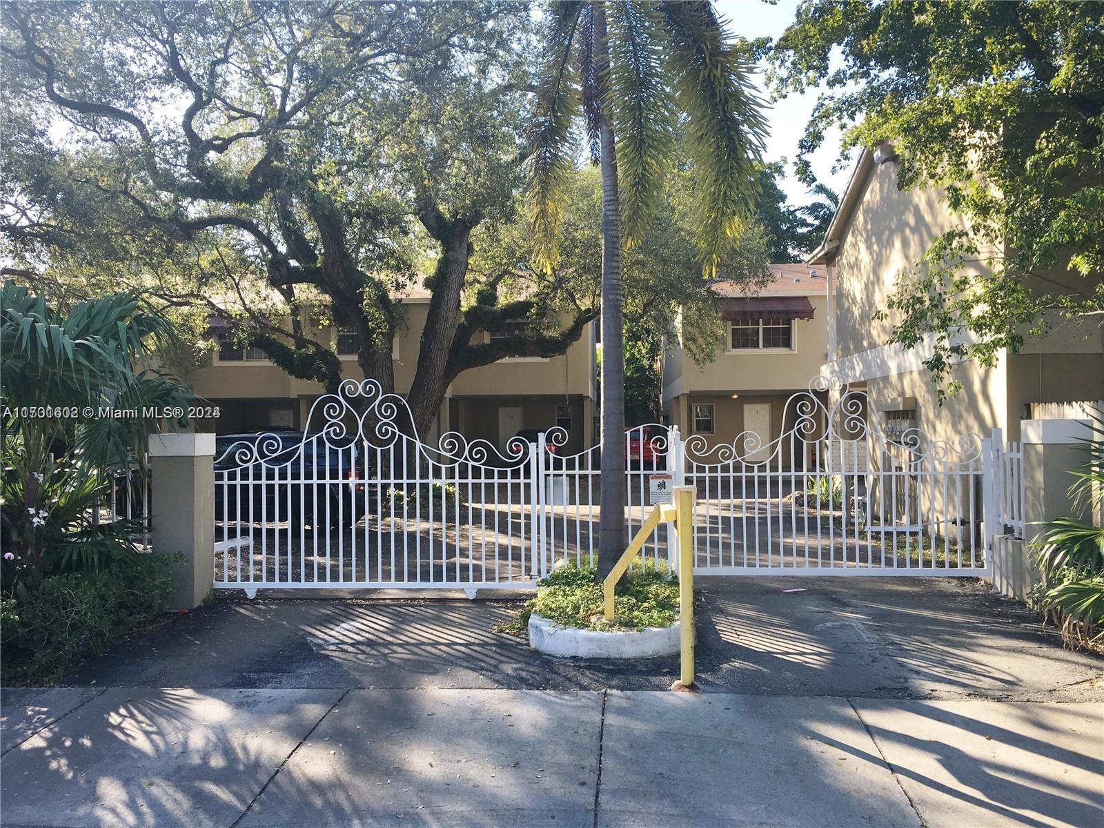 a view of a house with a wooden fence