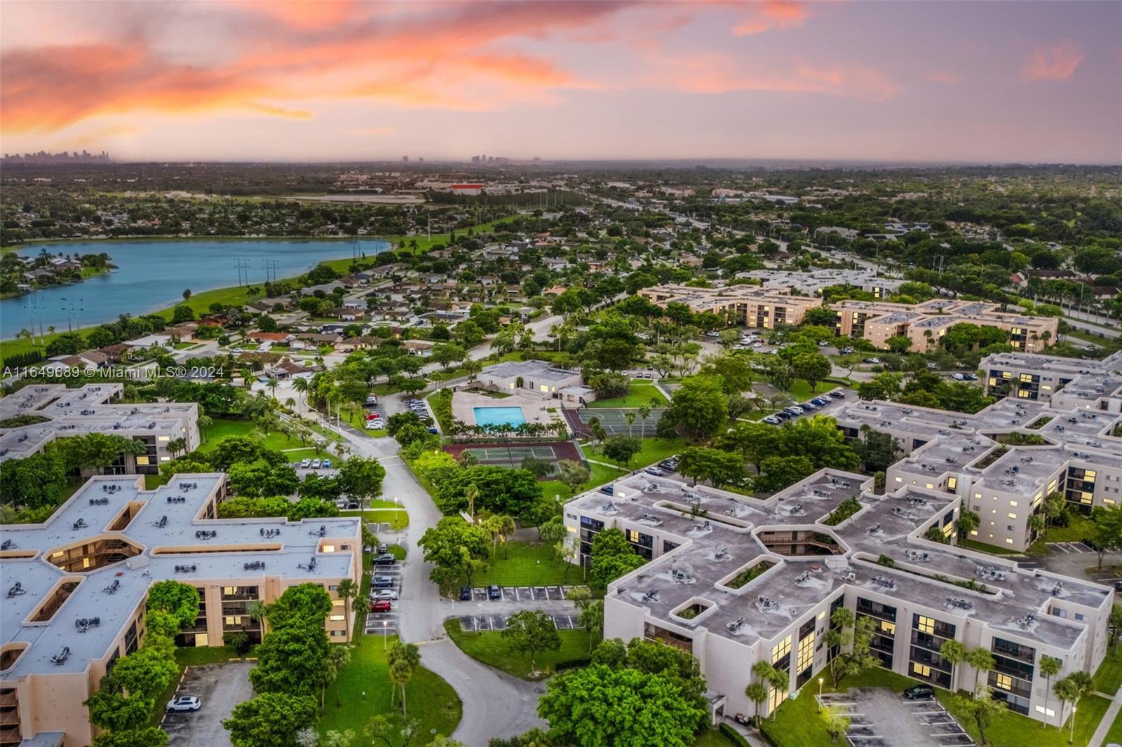 an aerial view of a city with lots of residential buildings and mountain view in back