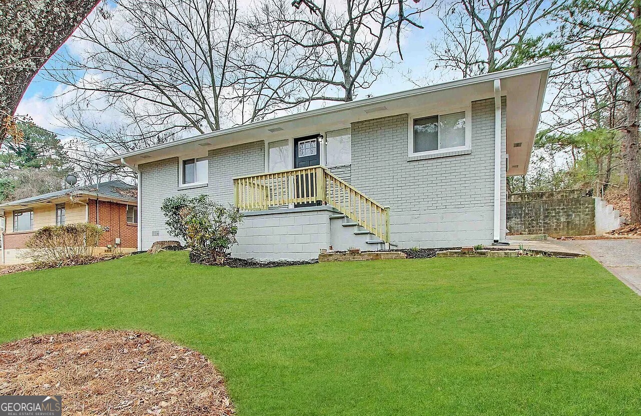 a front view of house with yard and green space