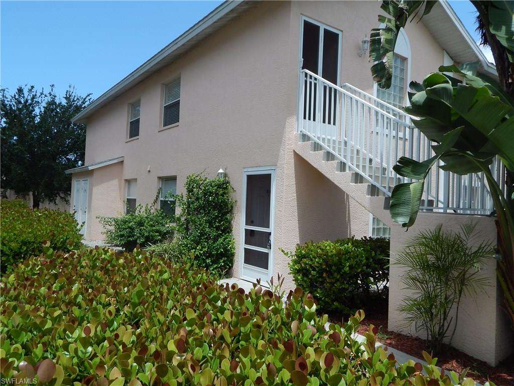 a view of a house with brick walls and flower plants