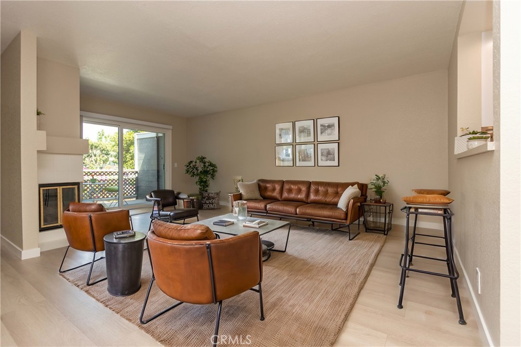 a living room with furniture a rug and a large window