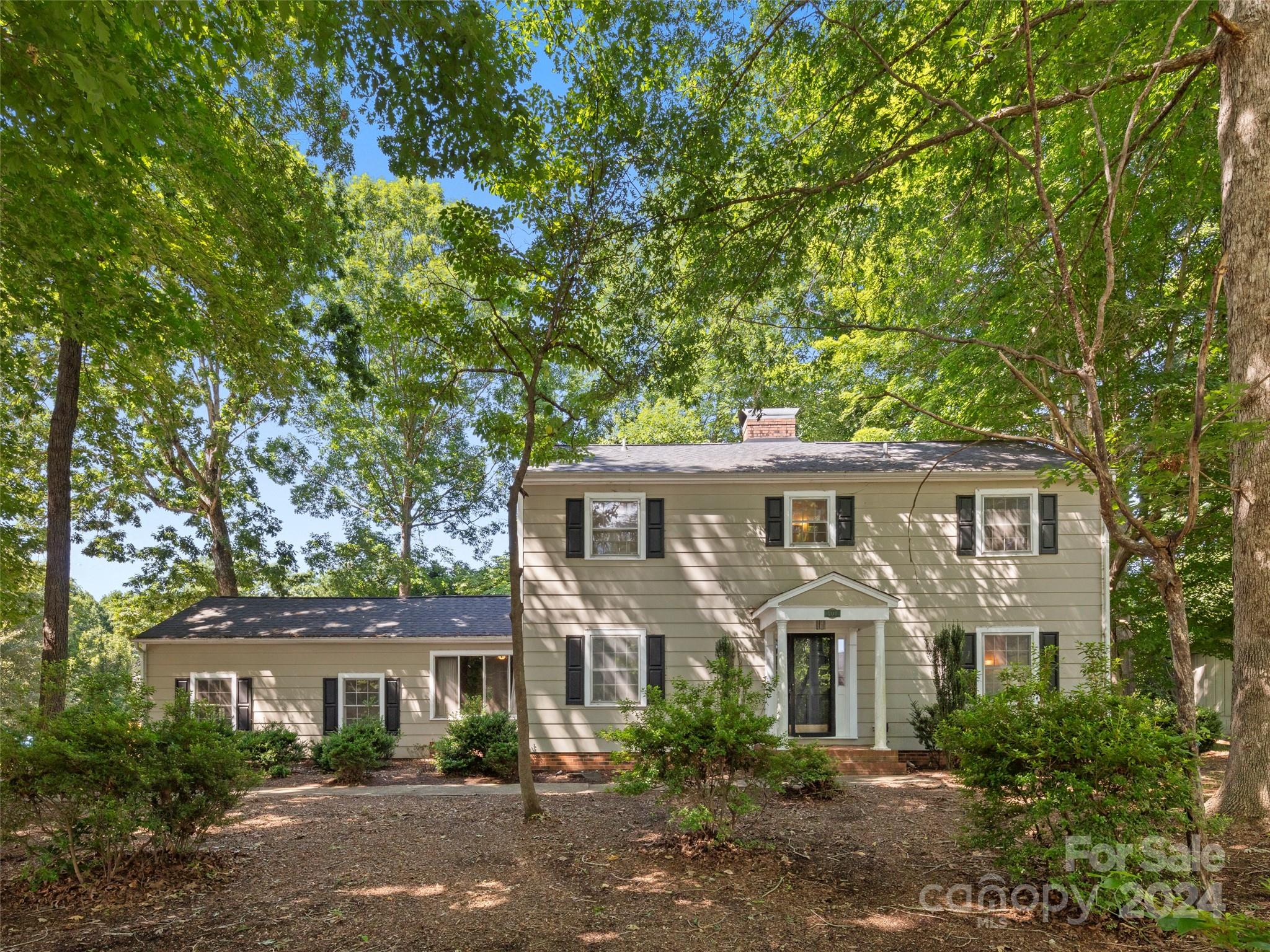 front view of a house with a tree