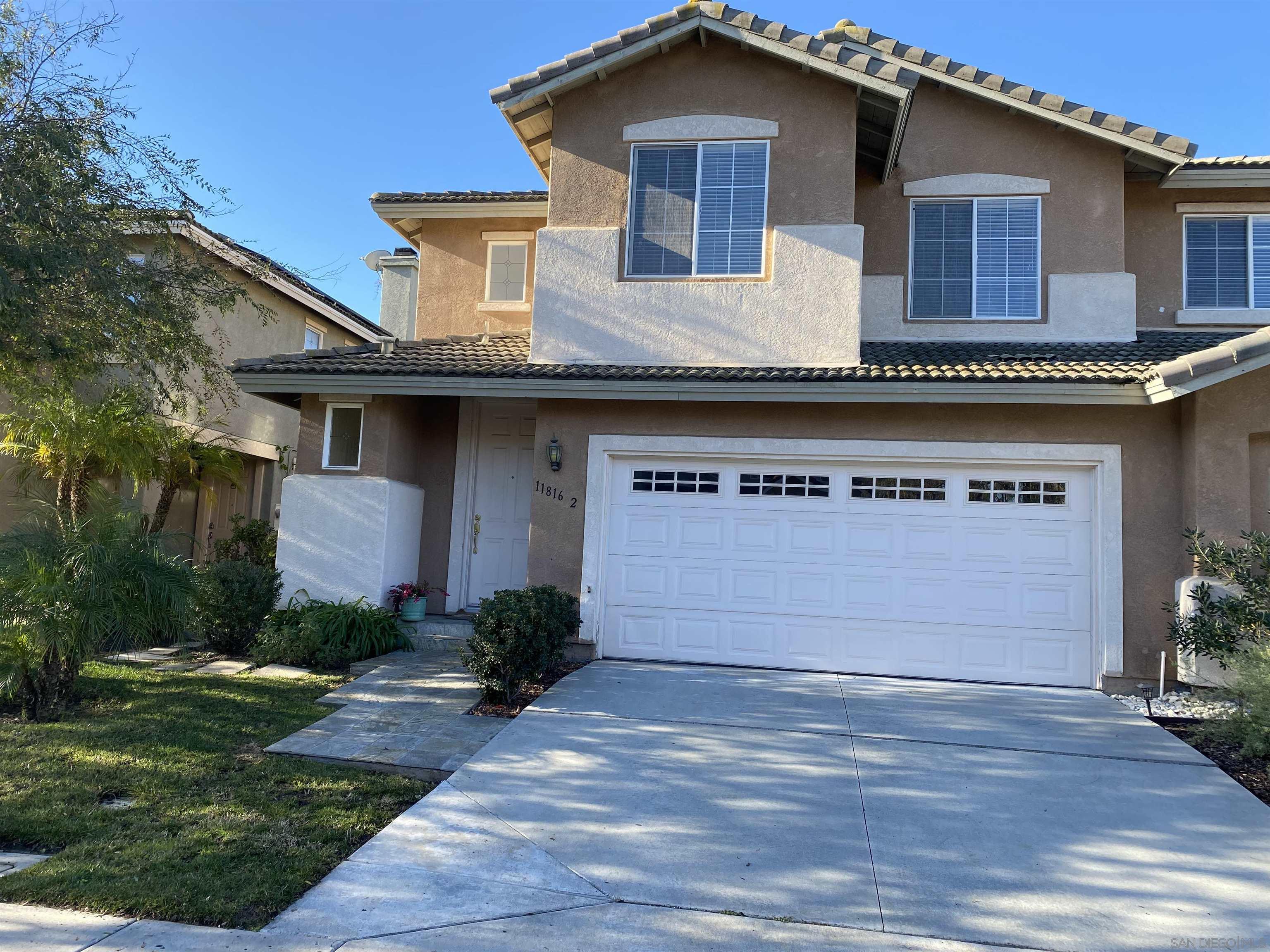 a front view of a house with a yard and garage