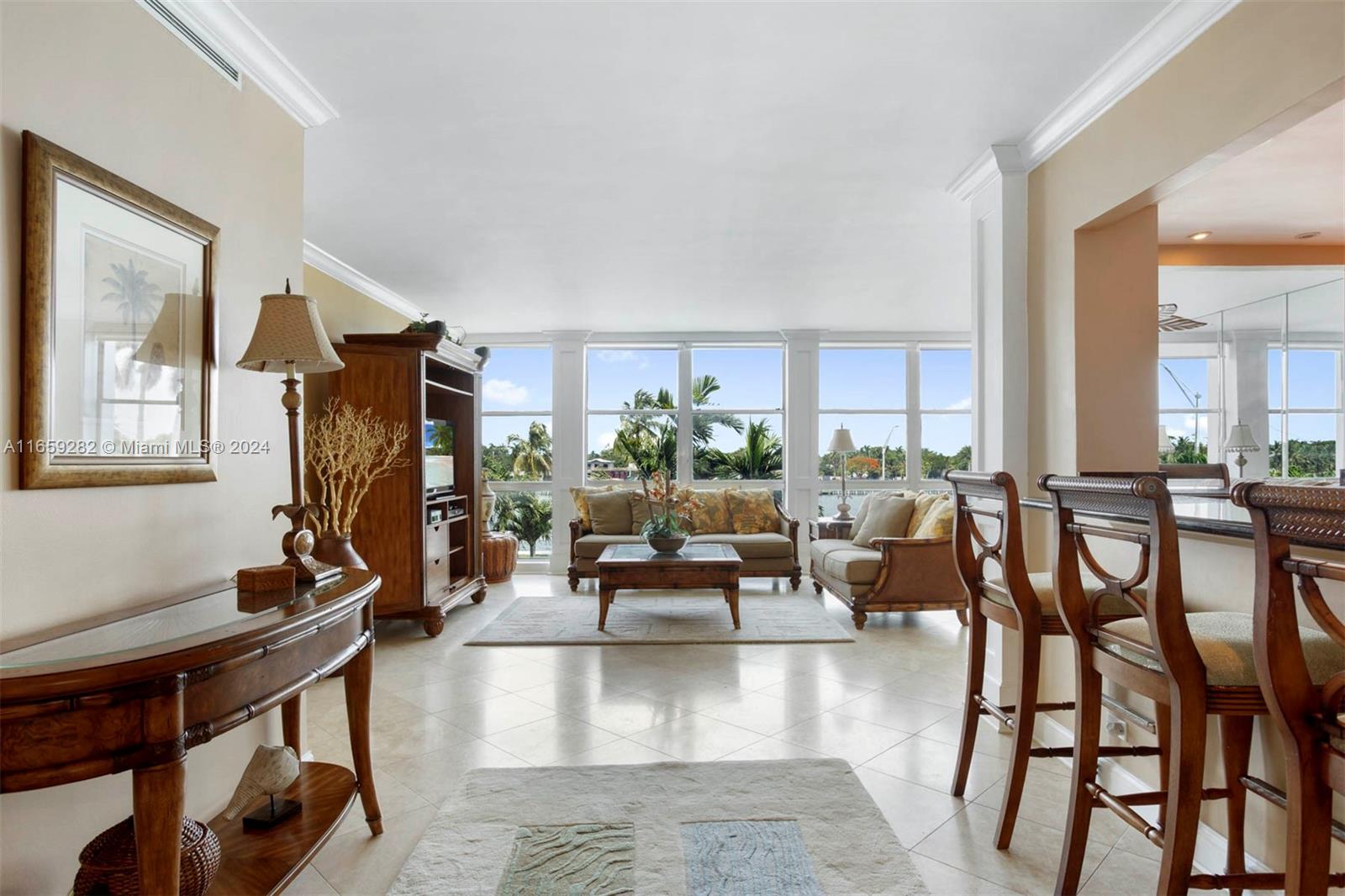 a living room with furniture large window and wooden floor