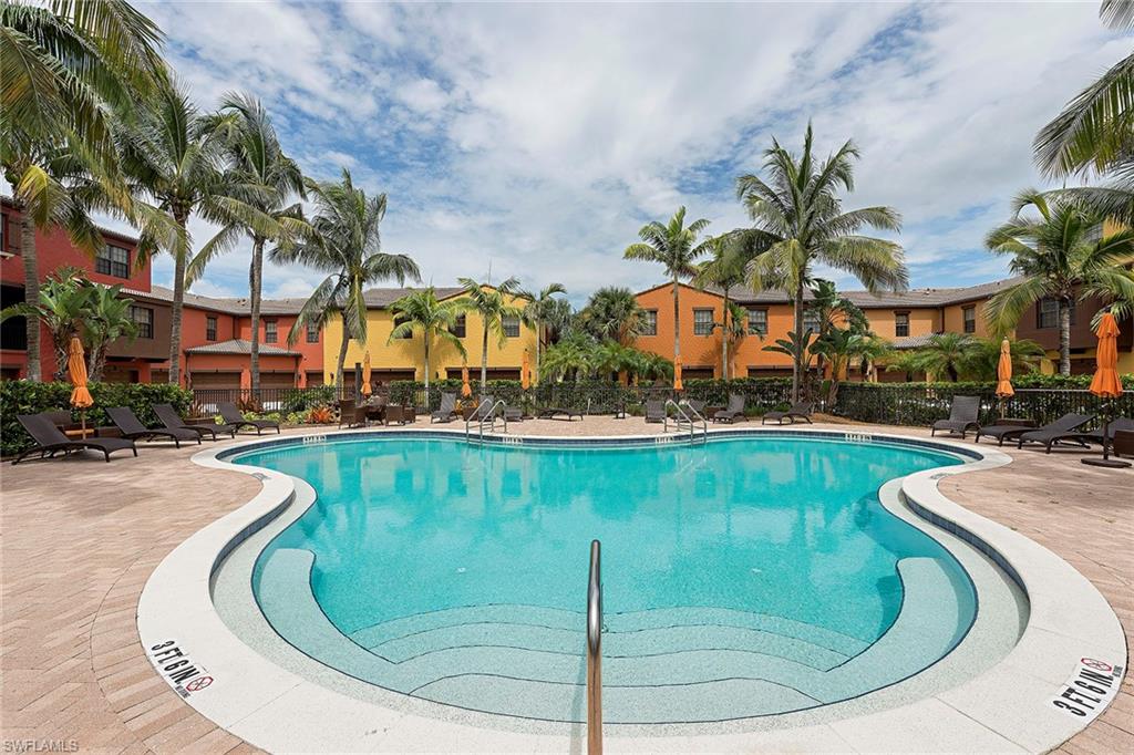 a view of a swimming pool with outdoor seating