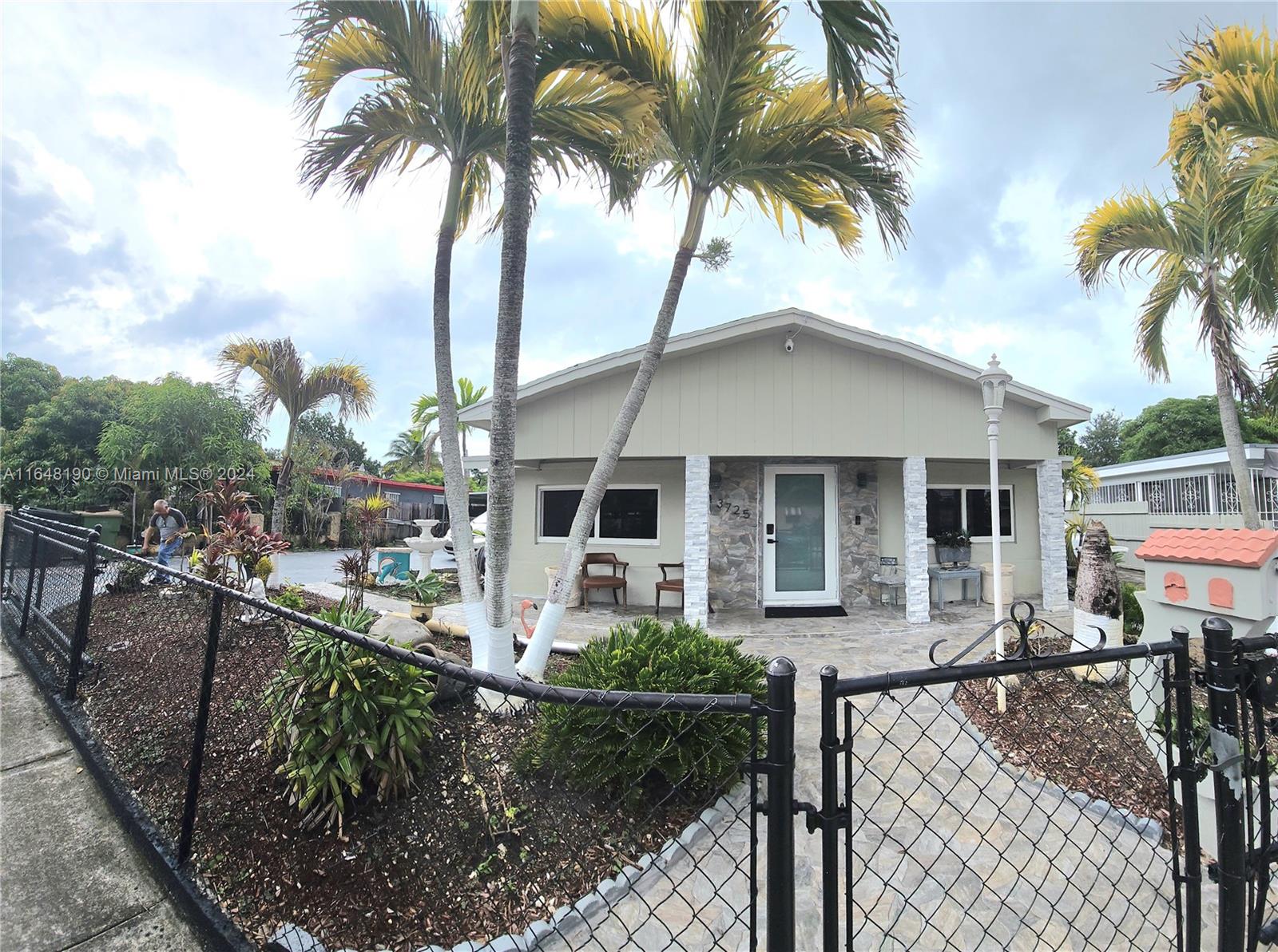 a front view of a house with garden and patio