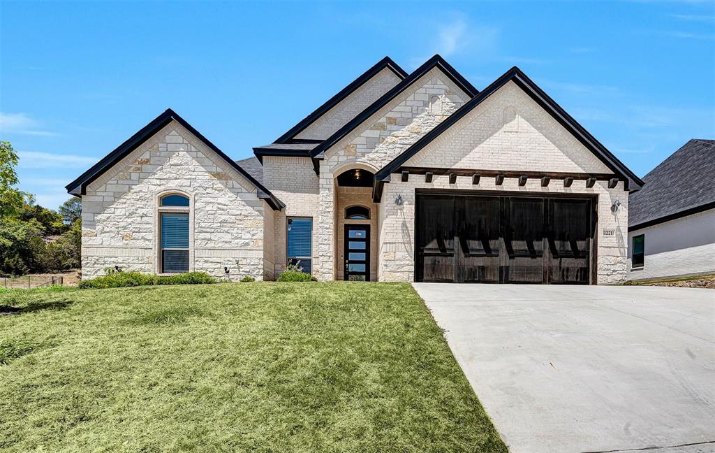 a front view of a house with a yard and garage