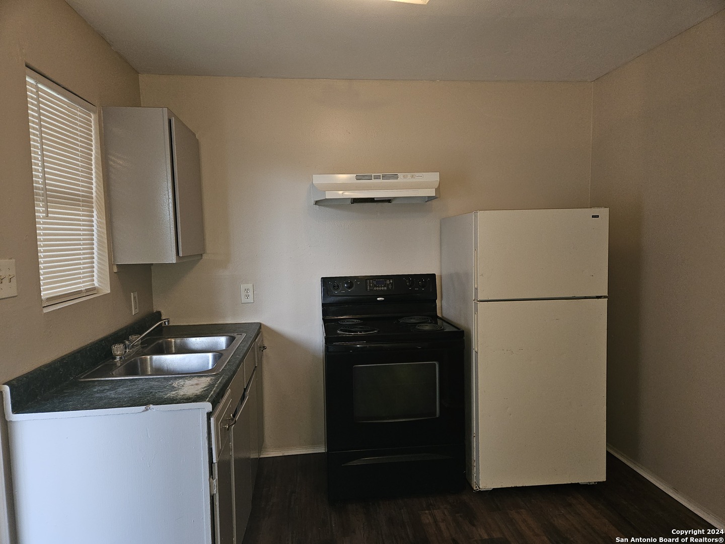 a kitchen with a refrigerator and a stove