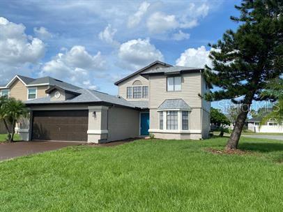 a front view of house with yard and green space