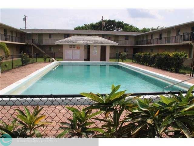 a view of a white house with a swimming pool