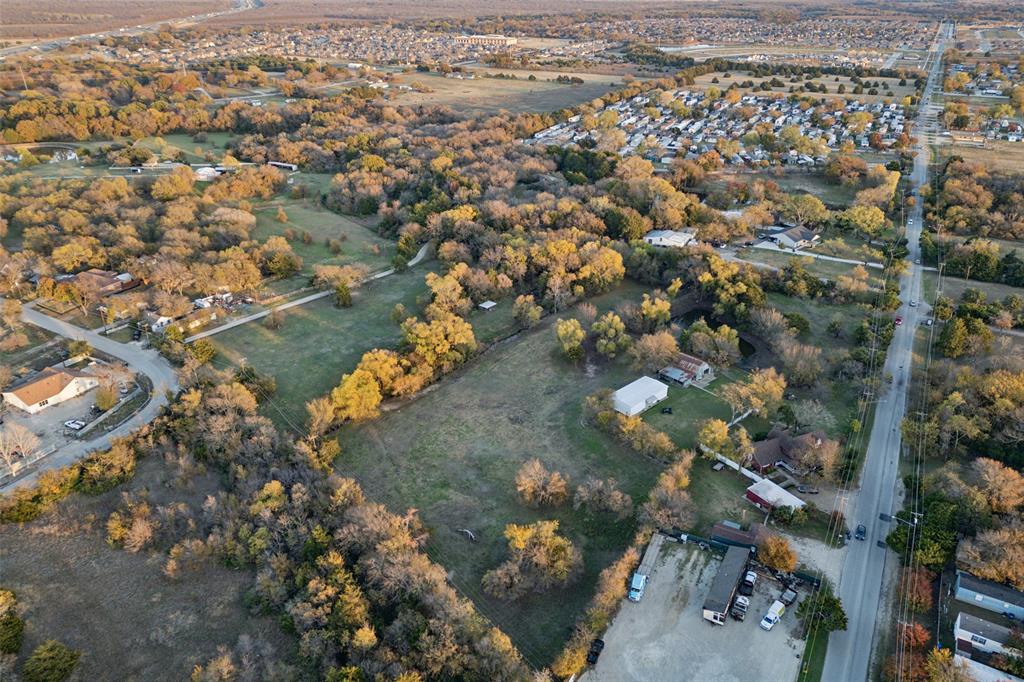 an aerial view of a houses with a yard