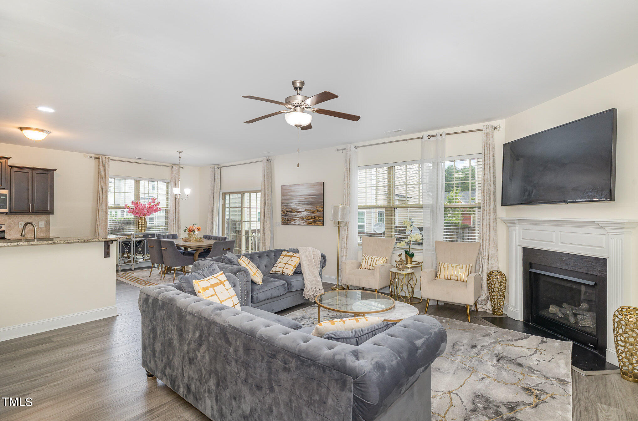 a living room with fireplace furniture and a flat screen tv