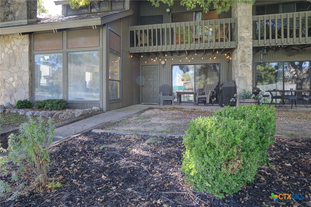 a view of a house with sitting area and garden