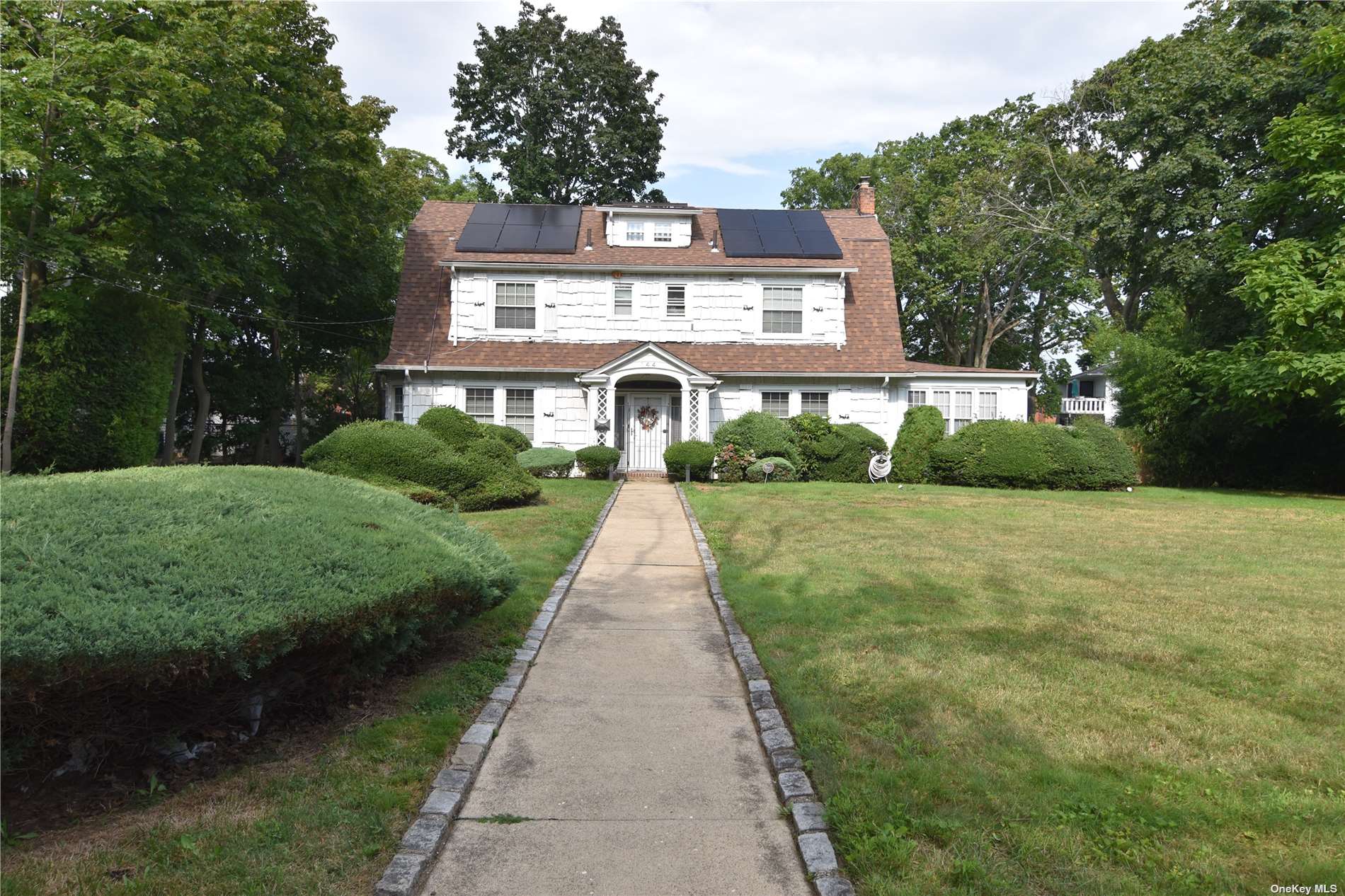 a front view of a house with yard