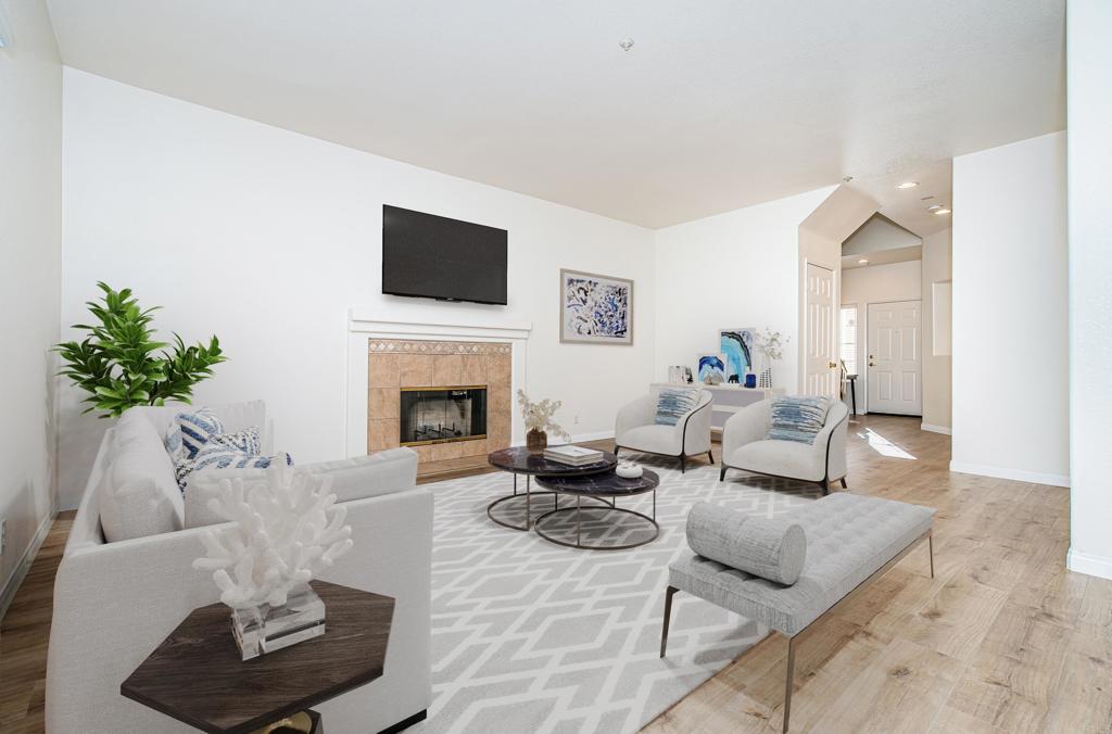 a living room with furniture a fireplace and a flat screen tv